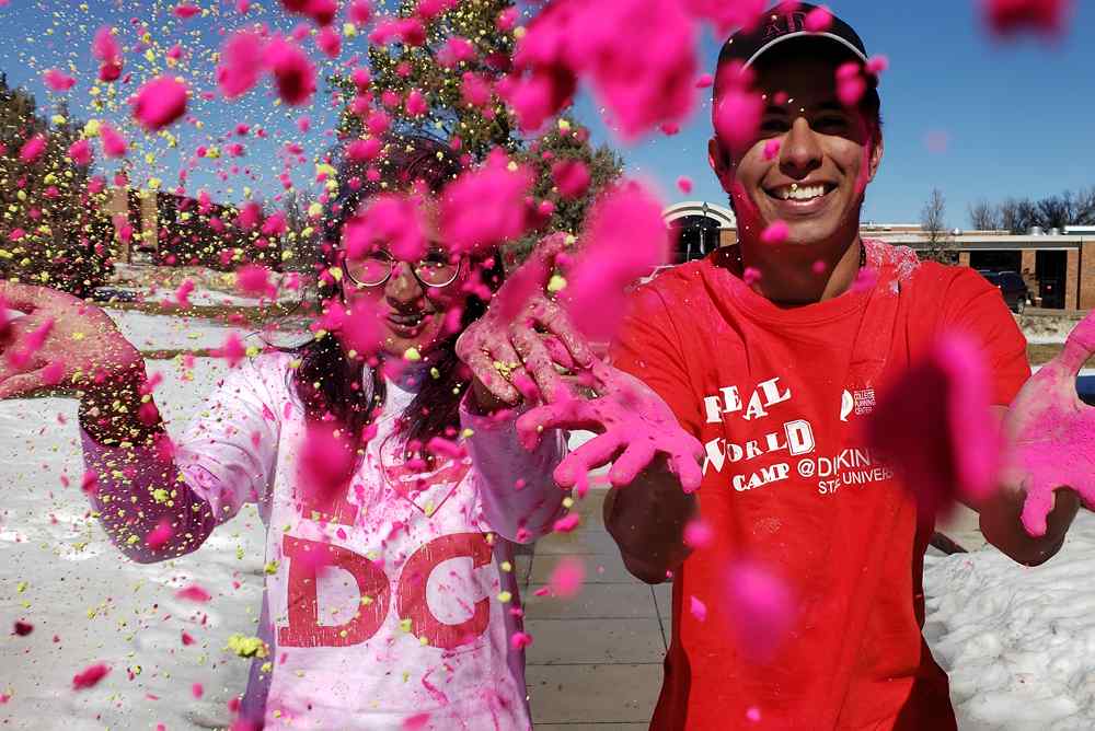 Students throwing color dye at the camera during an event