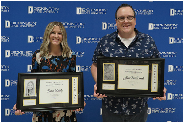 Dobitz and McDaniel holding their awards