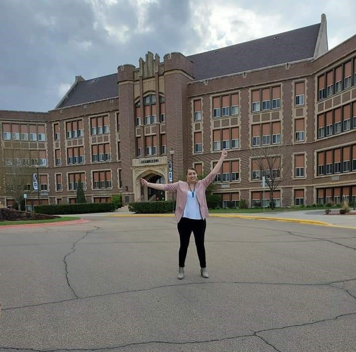 Mikayla Collins standing in front of May Hall a main DSU academic building