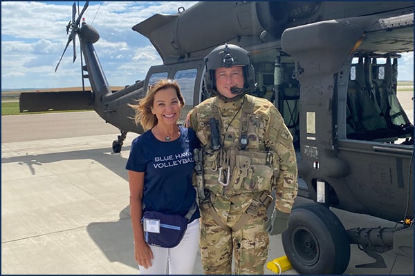 two people and a Black Hawk helicopter