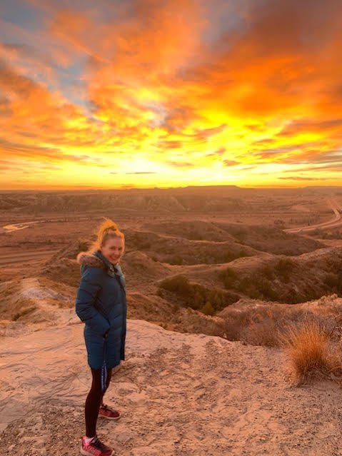 woman and badlands sunset