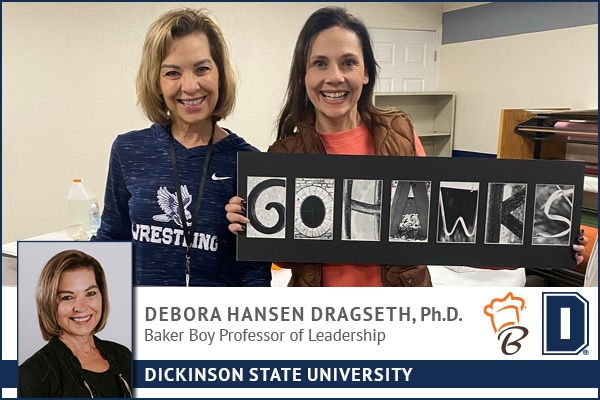 Debora Dragseth and Cebe Schneider pose with their homemade signs.