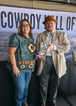 Mary Pat Martell Jones and Dr. William J. Hansard holding the award for Dr. Stickney.