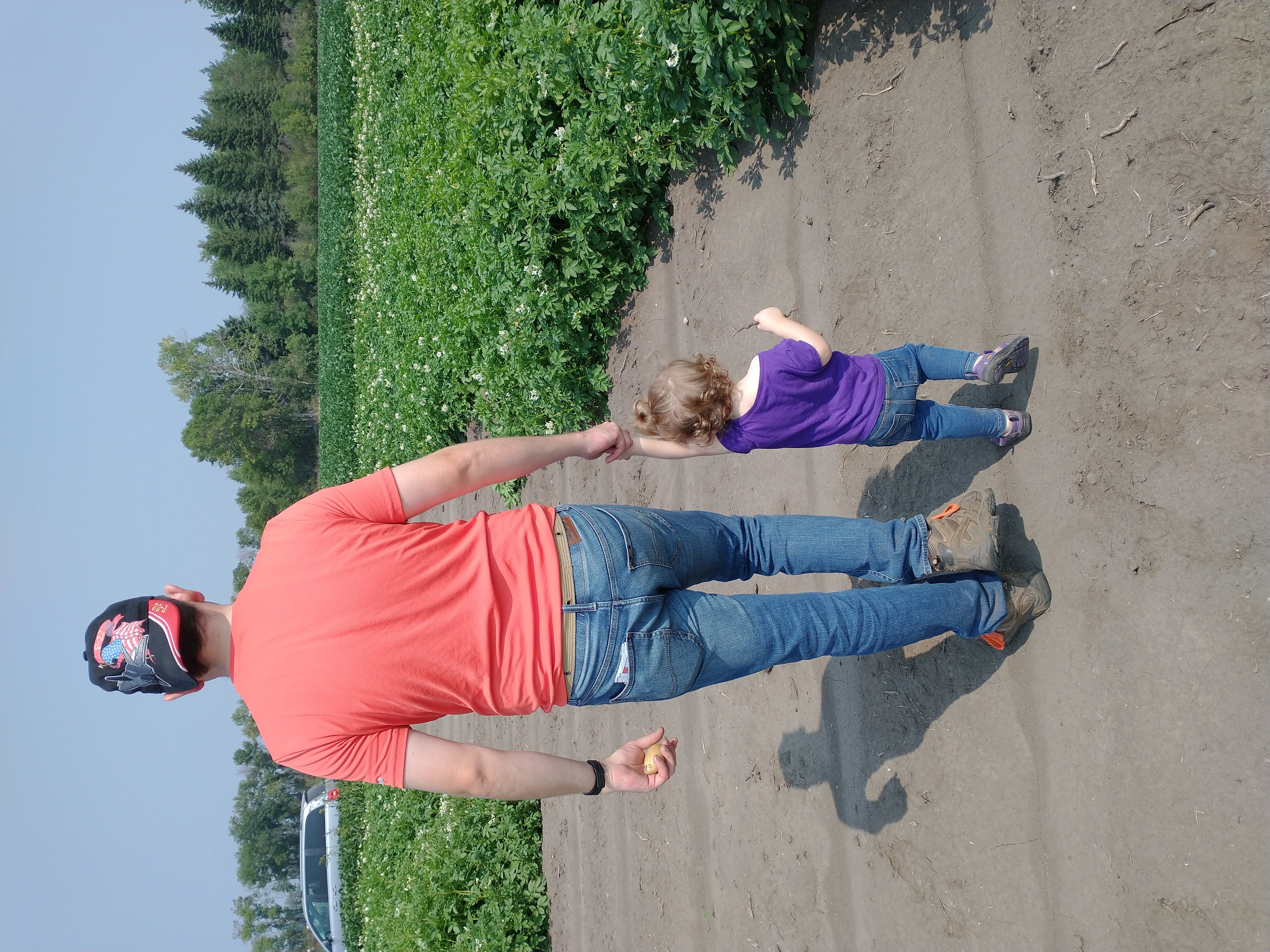 Dr. Grow with one of his children walking through a farm