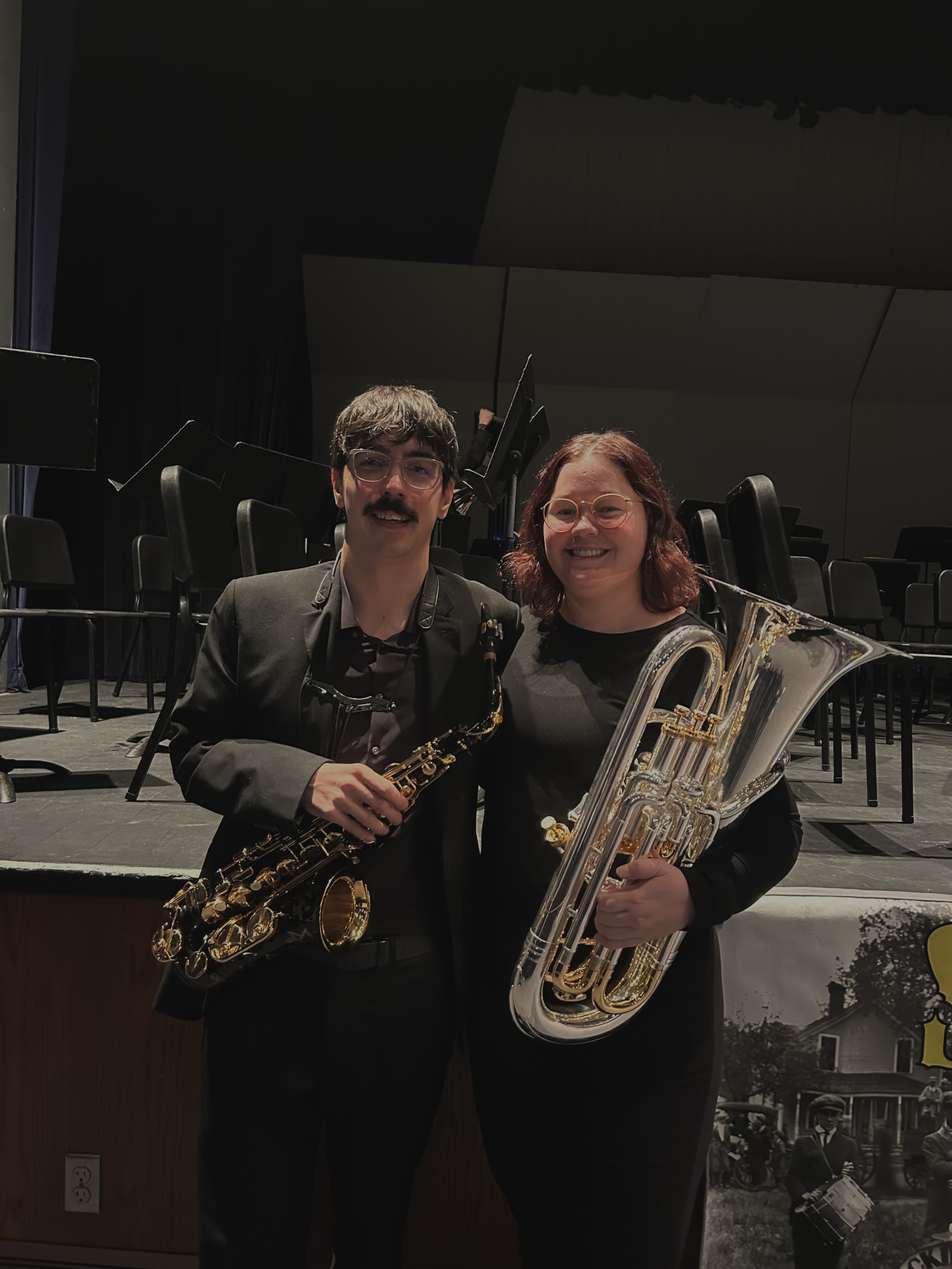 anna ellerkamp with her significant other holding musical insturments
