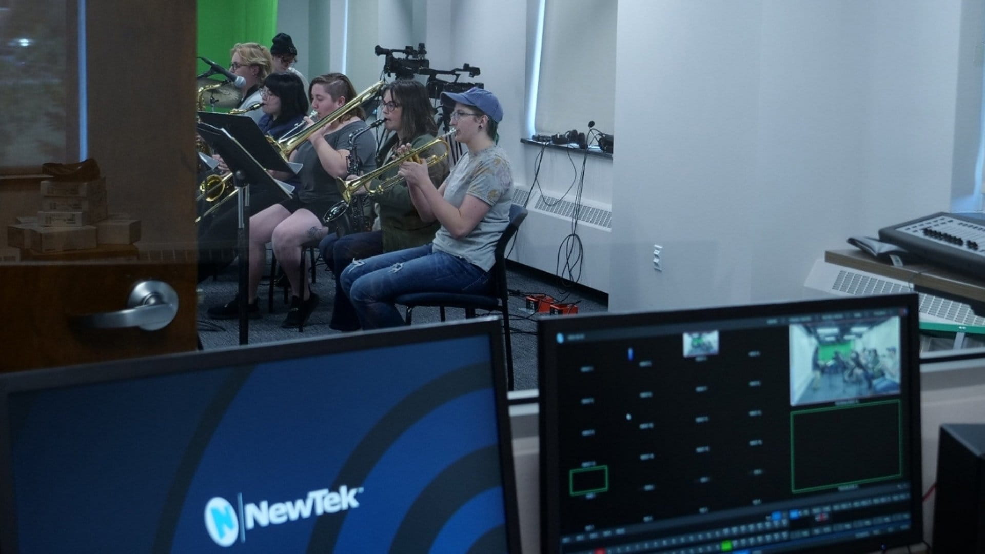 Control booth in the Hawk Media Lab also shows students playing instruments